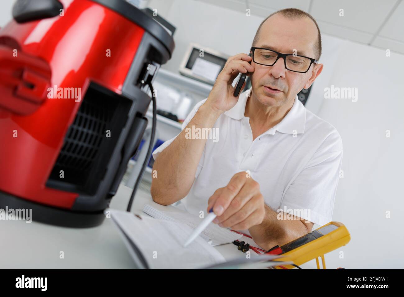 man repairing a coffee maker Stock Photo