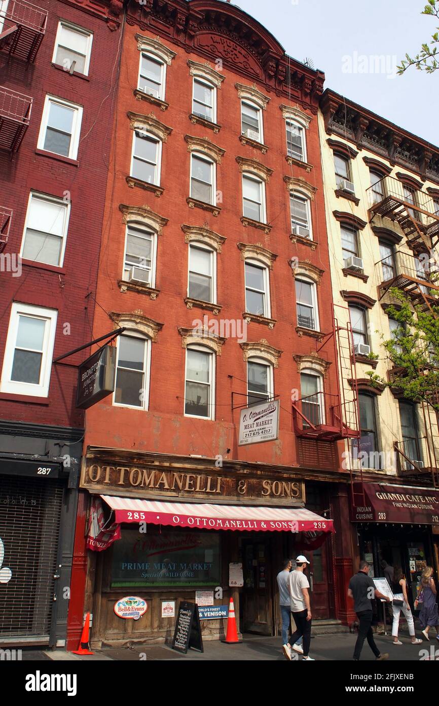 Facade of the late 19th-century multistory apartment building with old retail store in the ground floor, at 285 Bleecker Street, in the South Village Stock Photo