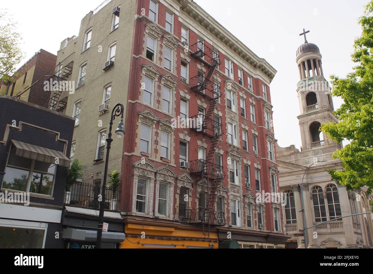 Facade of the late 19th-century multistory apartment building in the South Village neighborhood, at the corner of Bleecker and Carmine Streets, NYC Stock Photo