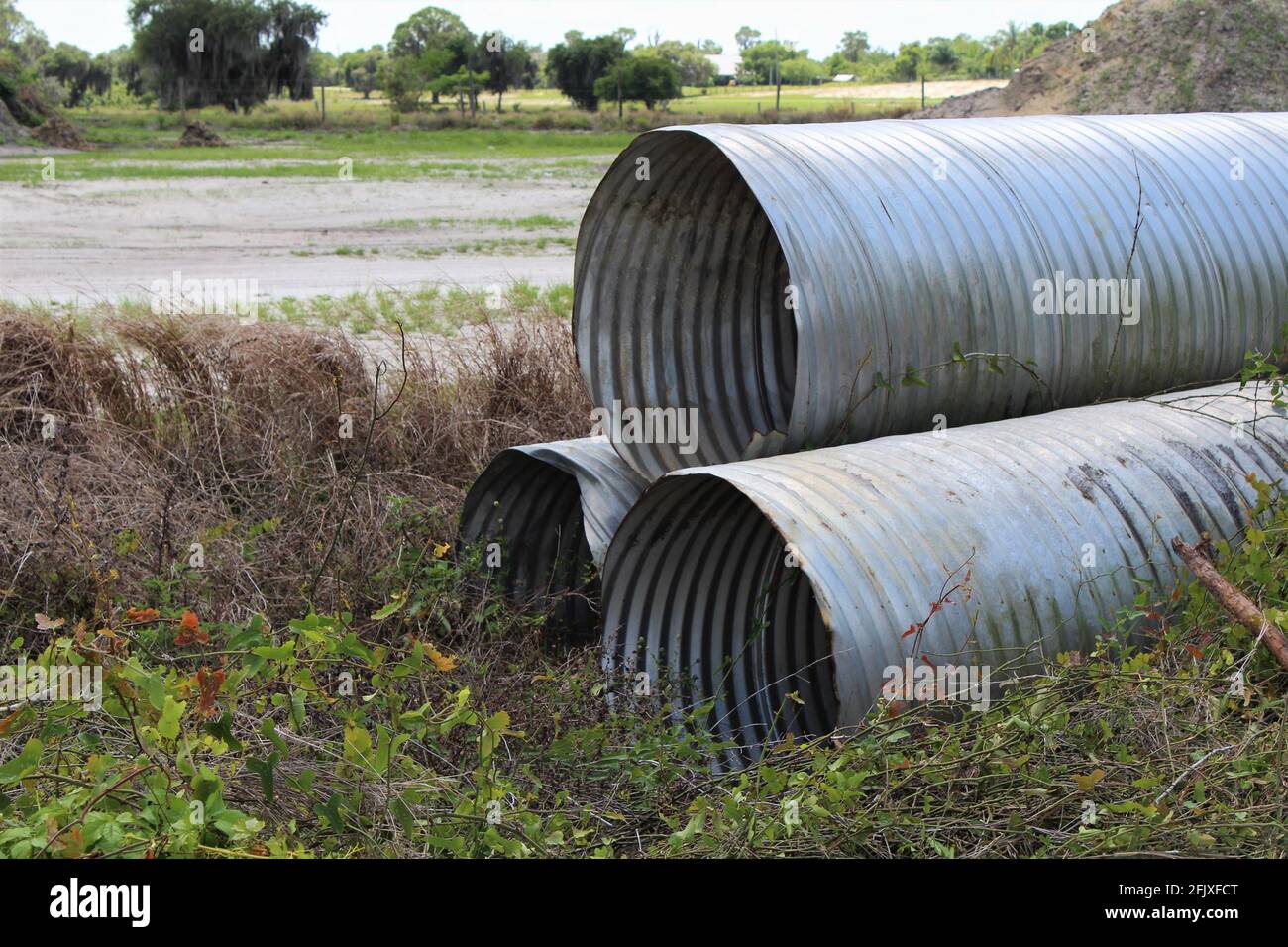 Large corrugated metal pipes for construction. Round metal drainage pipes Stock Photo Alamy