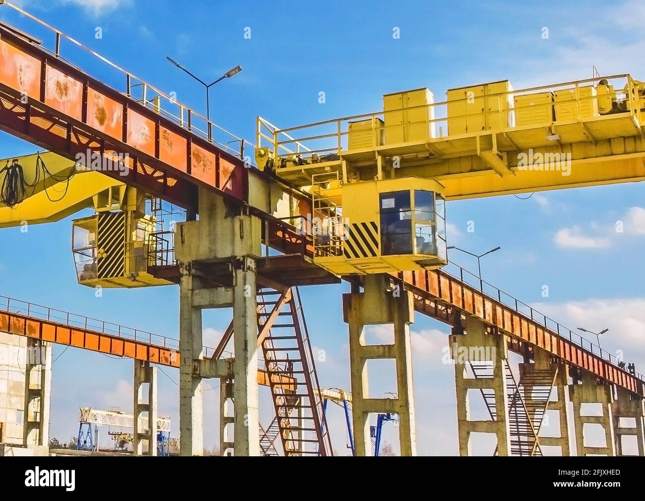 Overhead crane cabin at a construction site on a background of