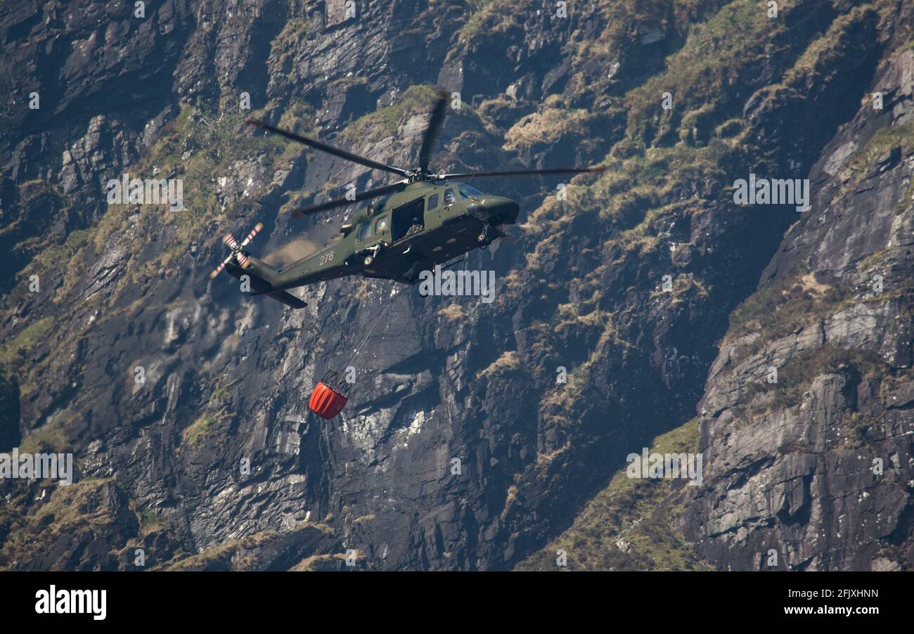 Killarney National Park, Ireland - 26th April.  2021:  Irish Air Corp Helicopter collecting water to extinguish fire in Killarney National park Stock Photo