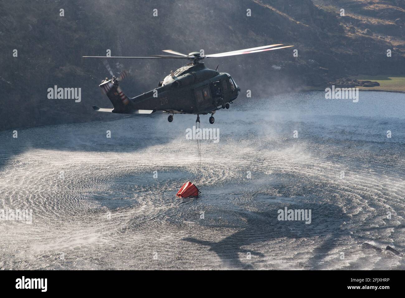 Killarney National Park, Ireland - 26th April.  2021:  Irish Air Corp Helicopter collecting water to extinguish fire in Killarney National park Stock Photo