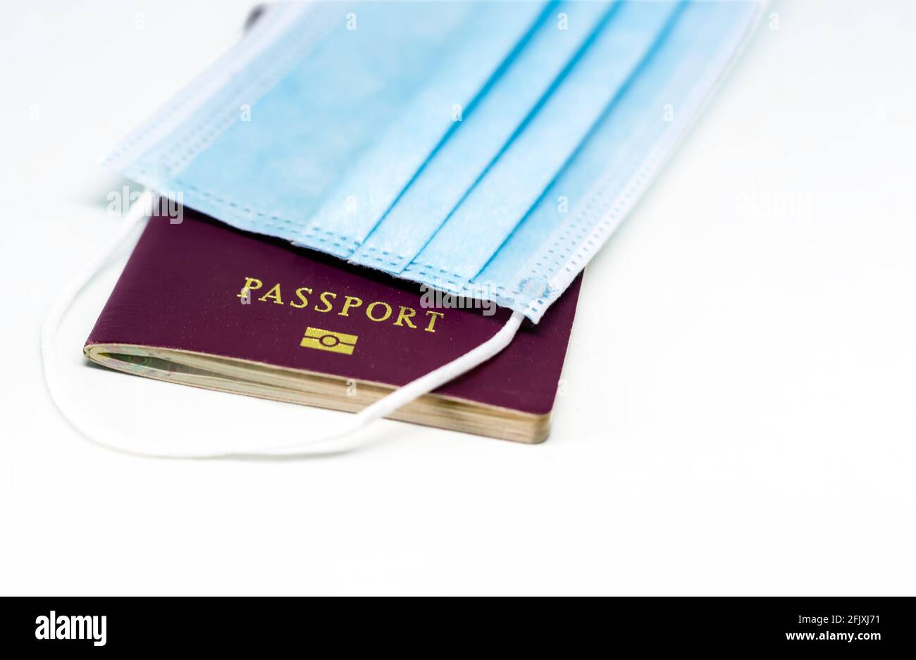 Surgical face mask over a passport. Traveling during the Covid 19