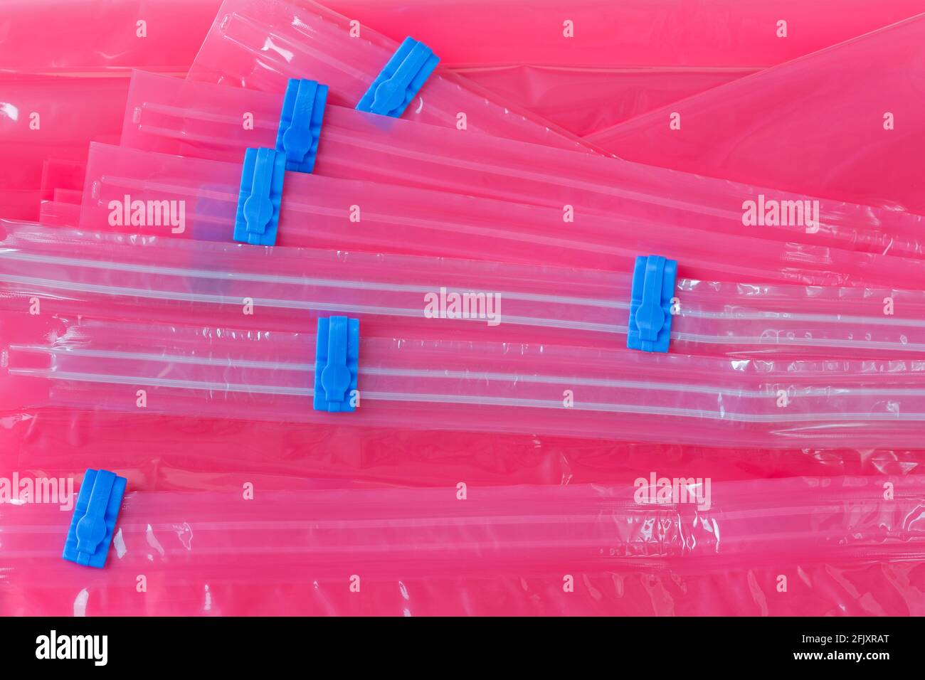 Closeup pink plastic zip lock bag with blue sealing to pack store cloths and resealable Stock Photo
