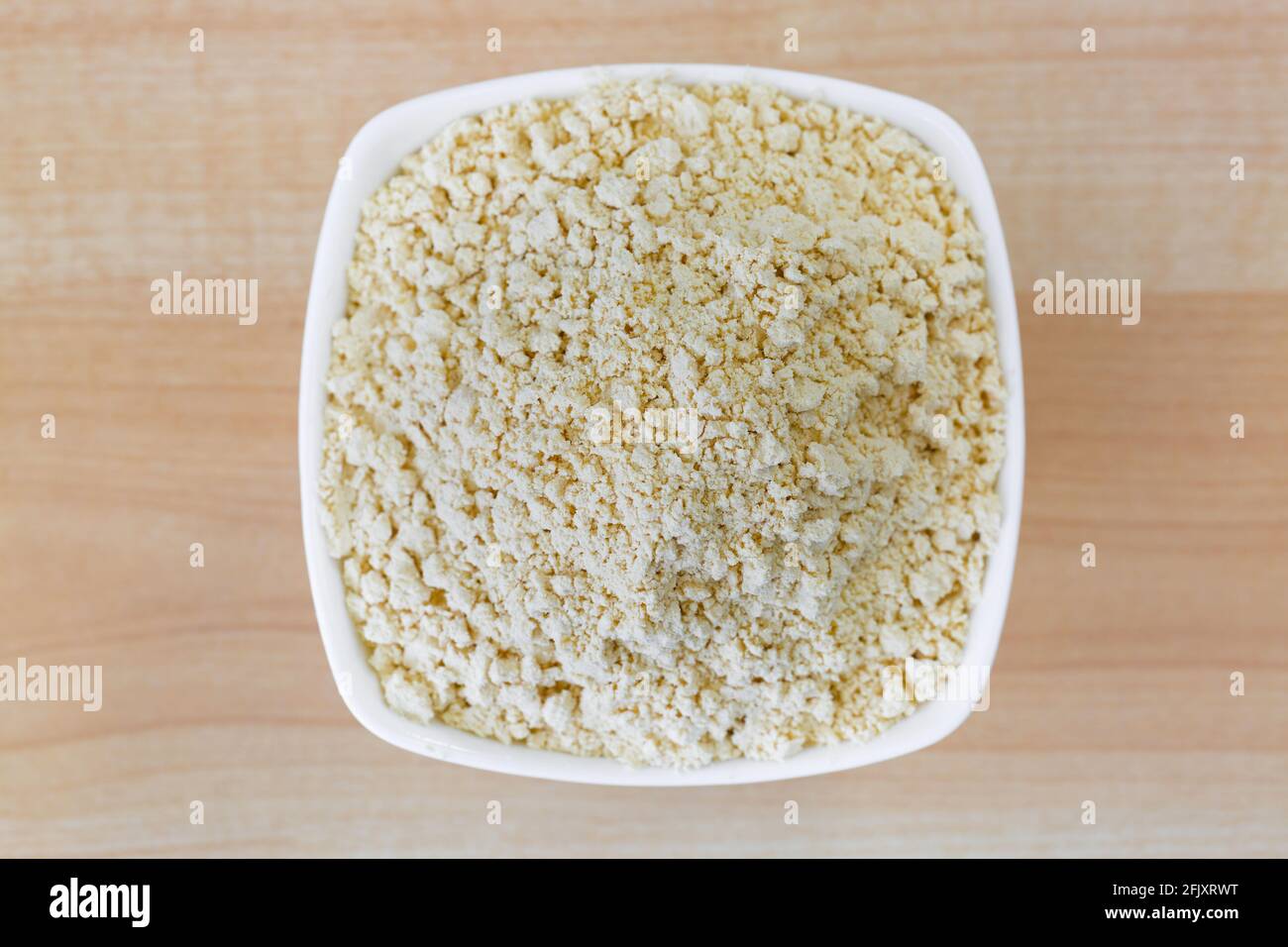 Dried soya powder, roasted ground soy bean flour powder in white bowl
