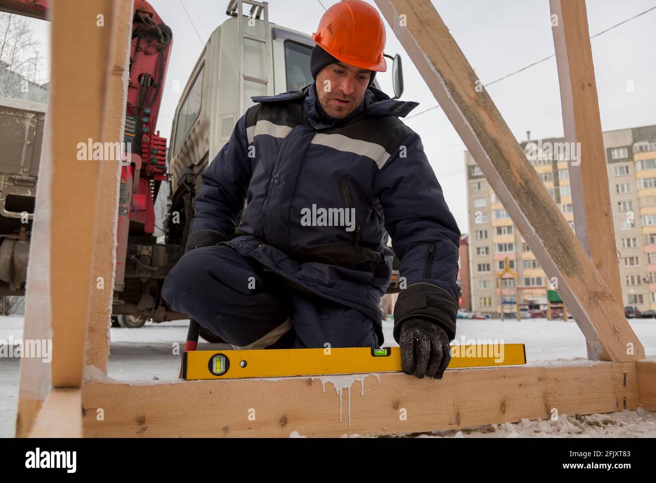 The worker sets the level of a wooden bar Stock Photo - Alamy