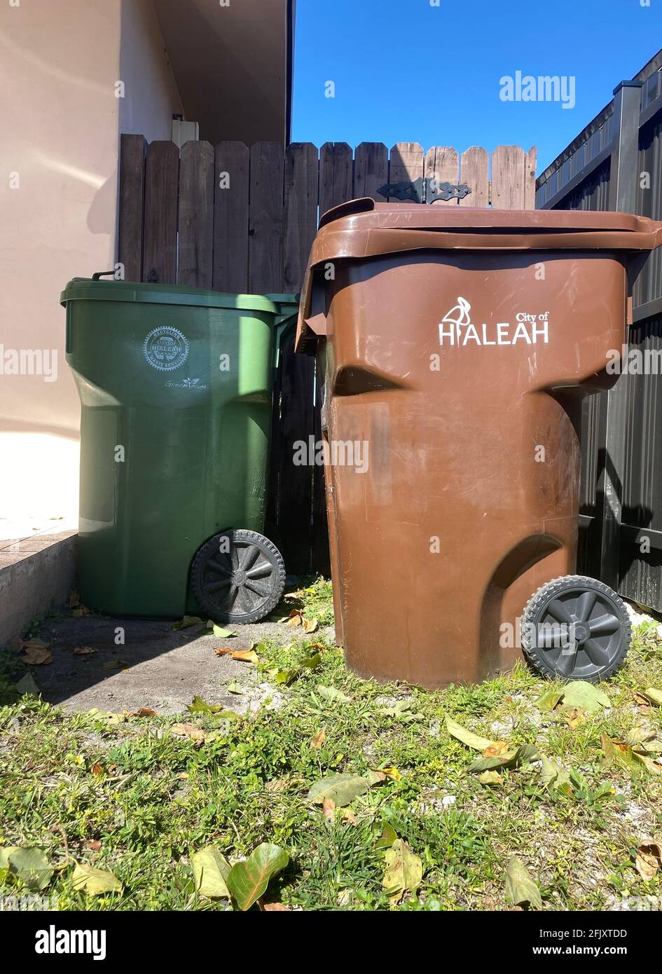 Garbage bin from The City of Hialeah near a residential home in Miami Dade County. Stock Photo