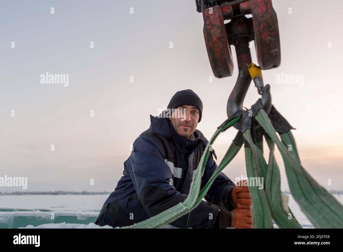 The slinger hooks the rope slings onto the hook of the truck crane Stock  Photo - Alamy