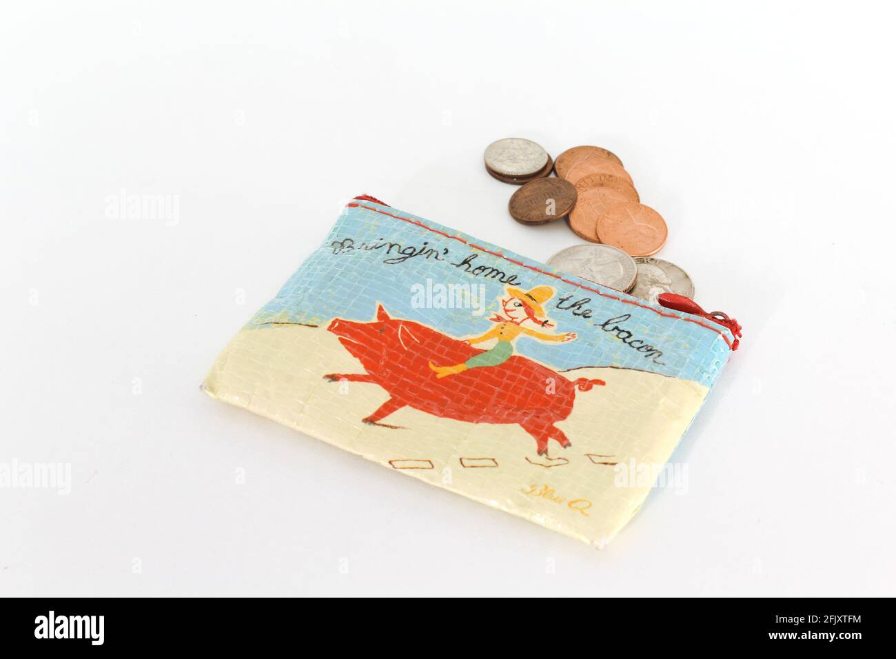Coin Purse that reads, Bringing Home the Bacon with change coming out. Illustrative money purse. Nickels, dimes, pennies and quarters. Stock Photo