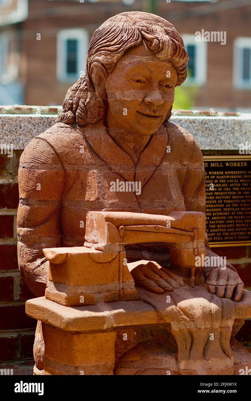 Mount Airy, North Carolina, USA - July 5, 2020: 'The Mill Worker' by artist Brad Spencer is part of 'The Whittling Wall' sculpture in Mount Airy. Stock Photo