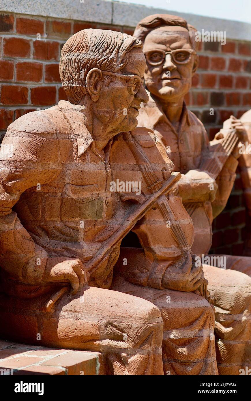 Mount Airy, North Carolina, USA - July 5, 2020:  'Tommy Jarrell' and 'Fred Cockerham' by artist Brad Spencer, part of 'The Whittling Wall' sculpture. Stock Photo