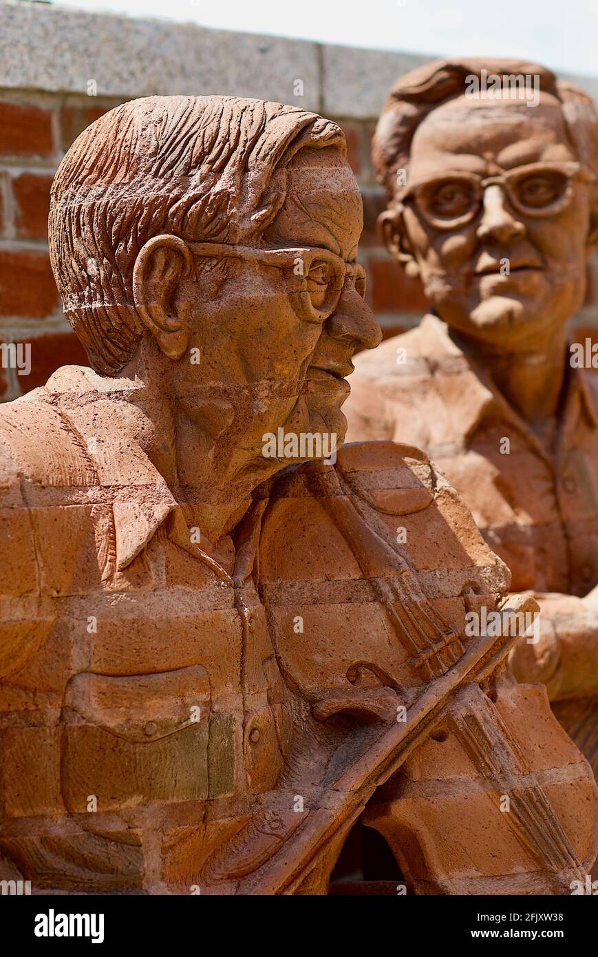 Mount Airy, North Carolina, USA - July 5, 2020:  'Tommy Jarrell' and 'Fred Cockerham' by artist Brad Spencer, part of 'The Whittling Wall' sculpture. Stock Photo