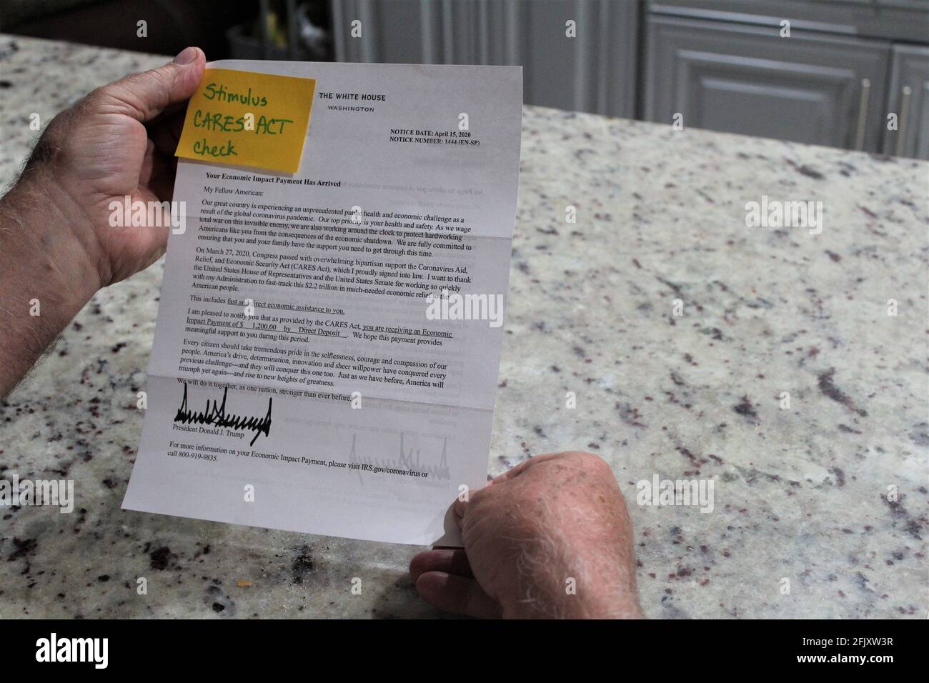 American receives a letter from Donald Trump & the IRS regarding Stimulus check for $1,200 because of the Corona virus COVID-19 pandemic. CARES ACT Stock Photo