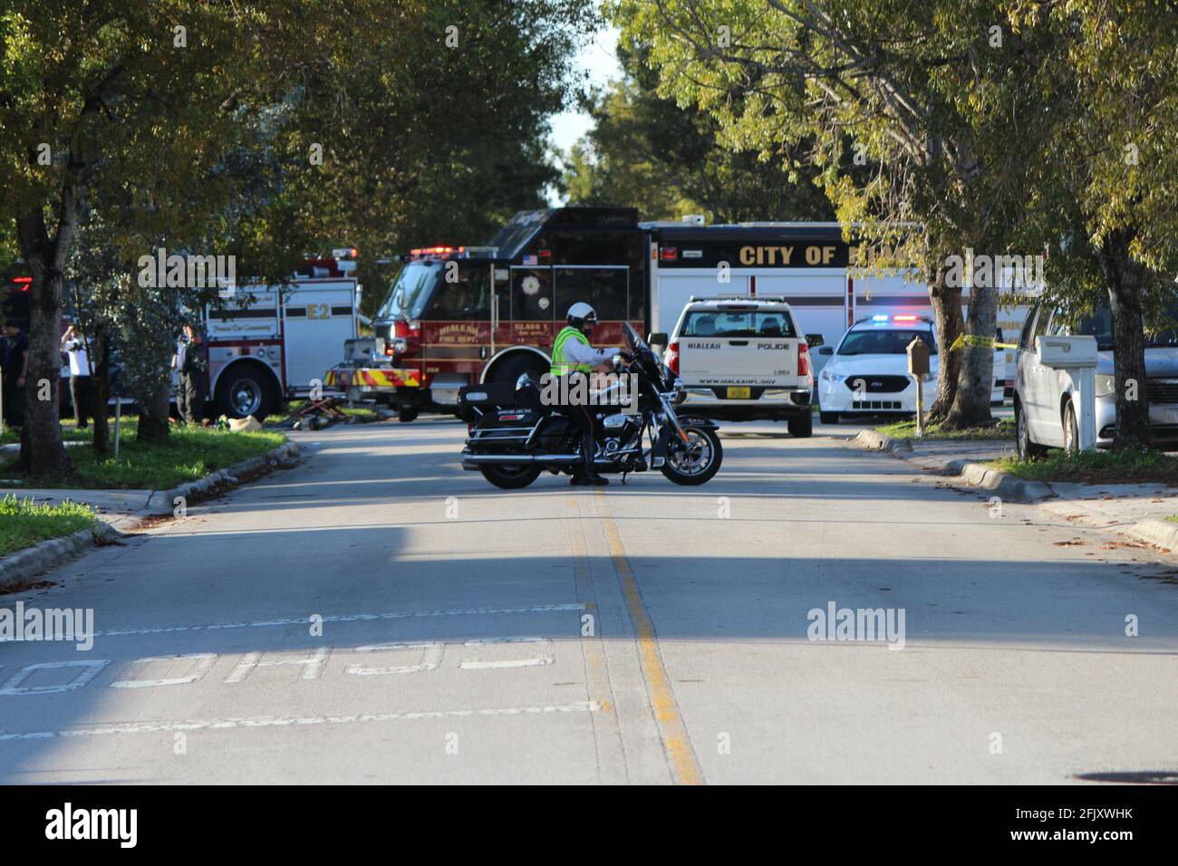 Hialeah Police officers and Fire Fighters arrive to a halt of a car chase crime scene where they blocked off many streets. Miami Dade county. Stock Photo