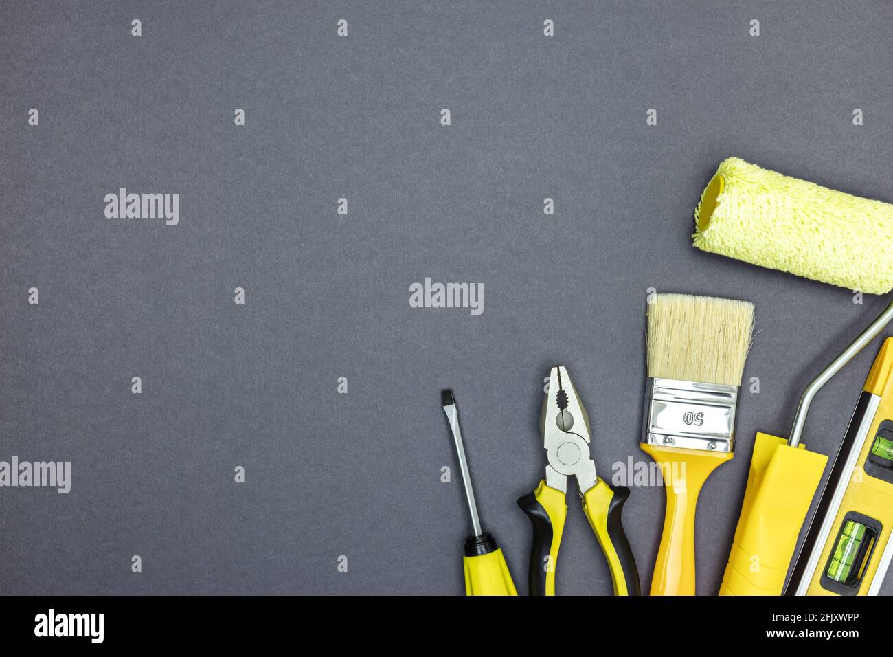 different construction tools on grey metal background. repair concept. top view, copy space Stock Photo