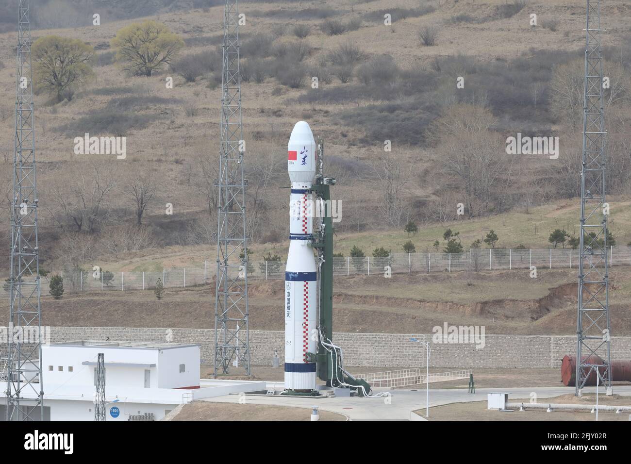 Shanxi, China. 27th Apr, 2021. A Long March-6 rocket prepares to blast off from the Taiyuan Satellite Launch Center in north China's Shanxi Province, April 27, 2021, sending nine commercial satellites into space. The satellites, including Qilu-1 and Qilu-4, have entered their planned orbits and will provide east China's Shandong Province with remote sensing services for land survey, urban construction, agriculture, forestry, energy, disaster prevention and reduction. Credit: Xinhua/Alamy Live News Stock Photo
