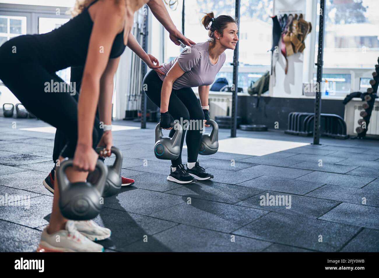Two young females working out with kettlebells Stock Photo Alamy