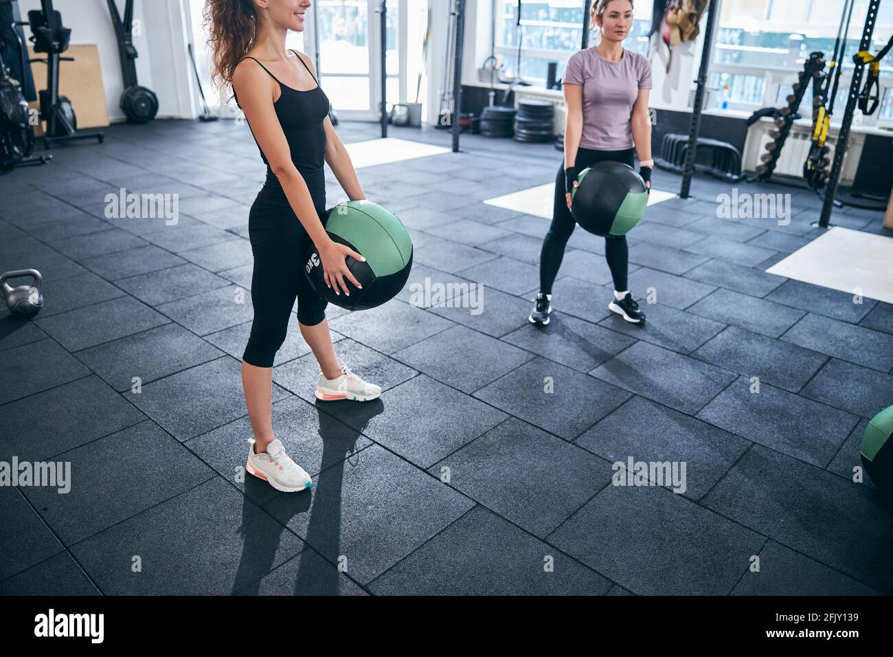 Two young female athletes performing an exercise Stock Photo