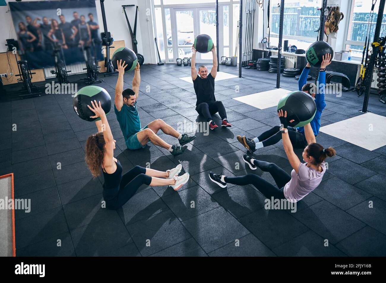 A group of men and women doing exercises with balls Image & Design ID  0000523068 