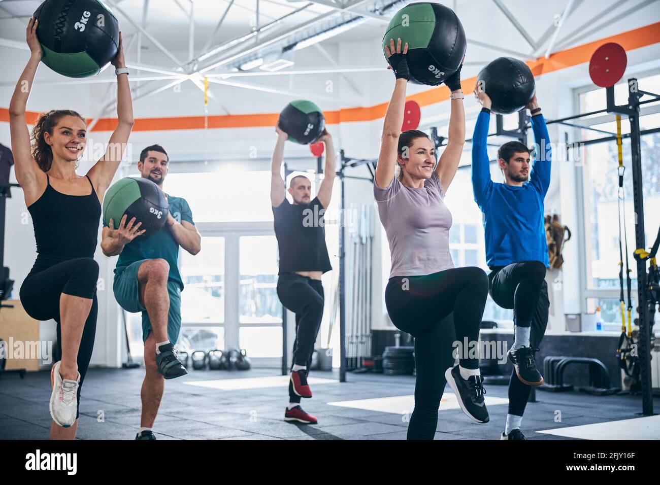 Well-built Caucasian men and women working out together Stock Photo