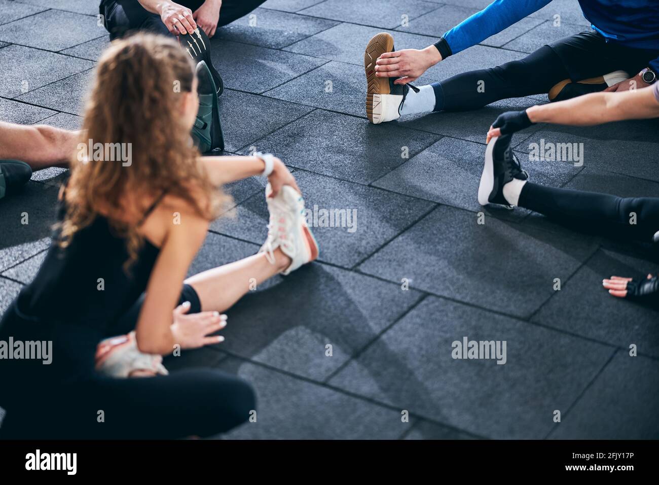 Five young people performing a stretching exercise Stock Photo