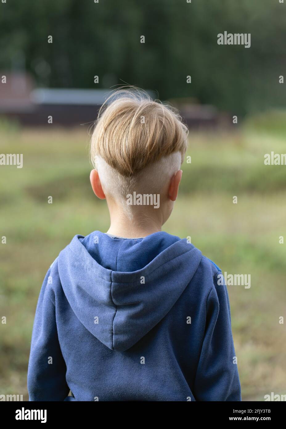 Portraits from back of boy with fashionable hairstyle in sports jacket on  blurred natural background. Model haircut or after visit to hairdresser.  Wal Stock Photo - Alamy