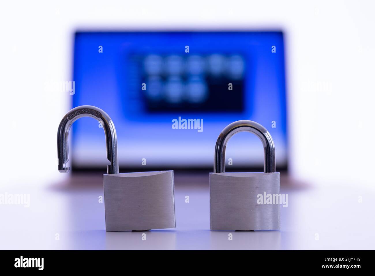 Privacy and data protection: Laptop and smartphone with padlock in foreground Stock Photo