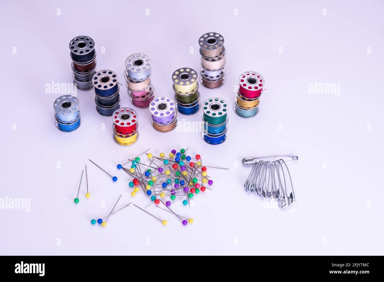 Inside a sewing kit: Colorful thread reels, pins, measuring tape and ...