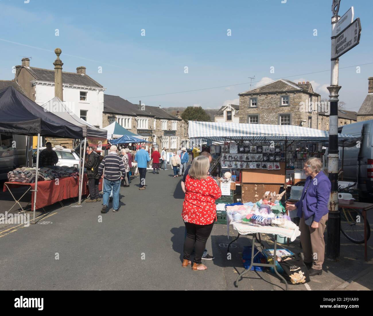 Shoppers in the the outdoor street market in Settle, Yorkshire, England, UK Stock Photo
