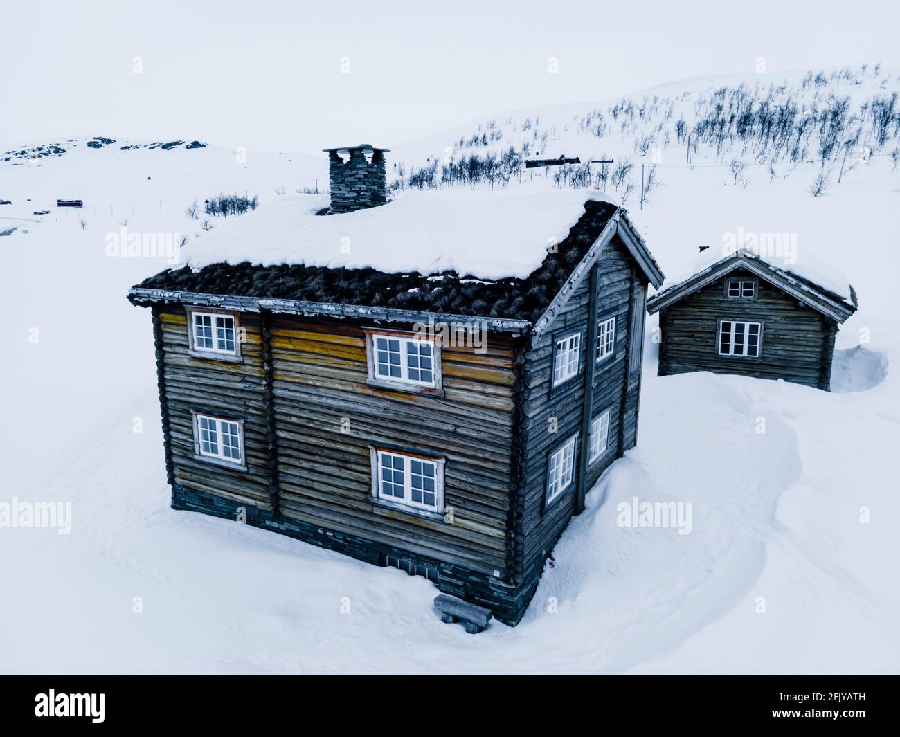 Classic large classic lumber log cabin on a snowy cold winters day. Stock Photo