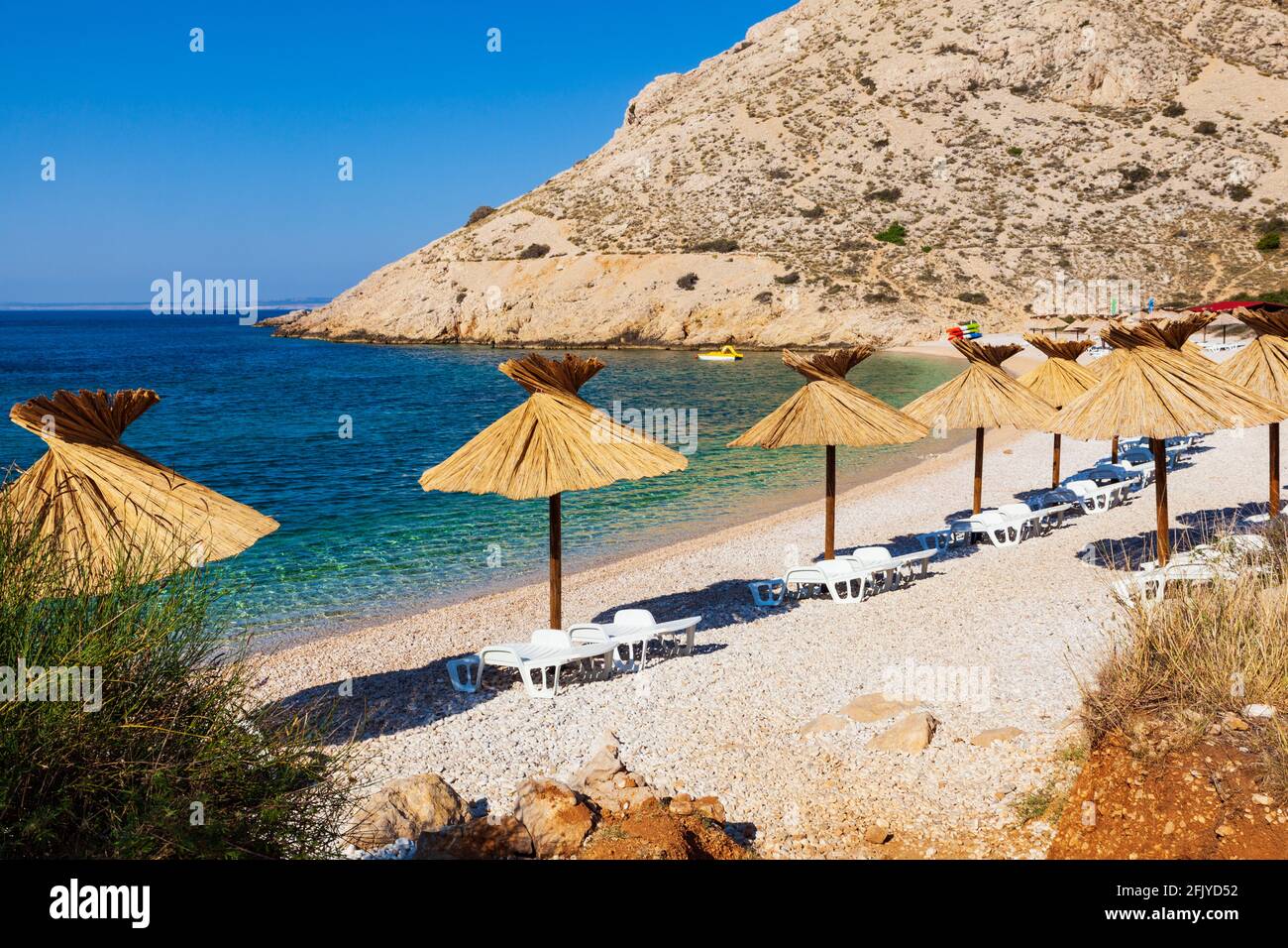 Straw umbrellas in the beautiful Oprna beach in the Krk island, Croatia Stock Photo Alamy
