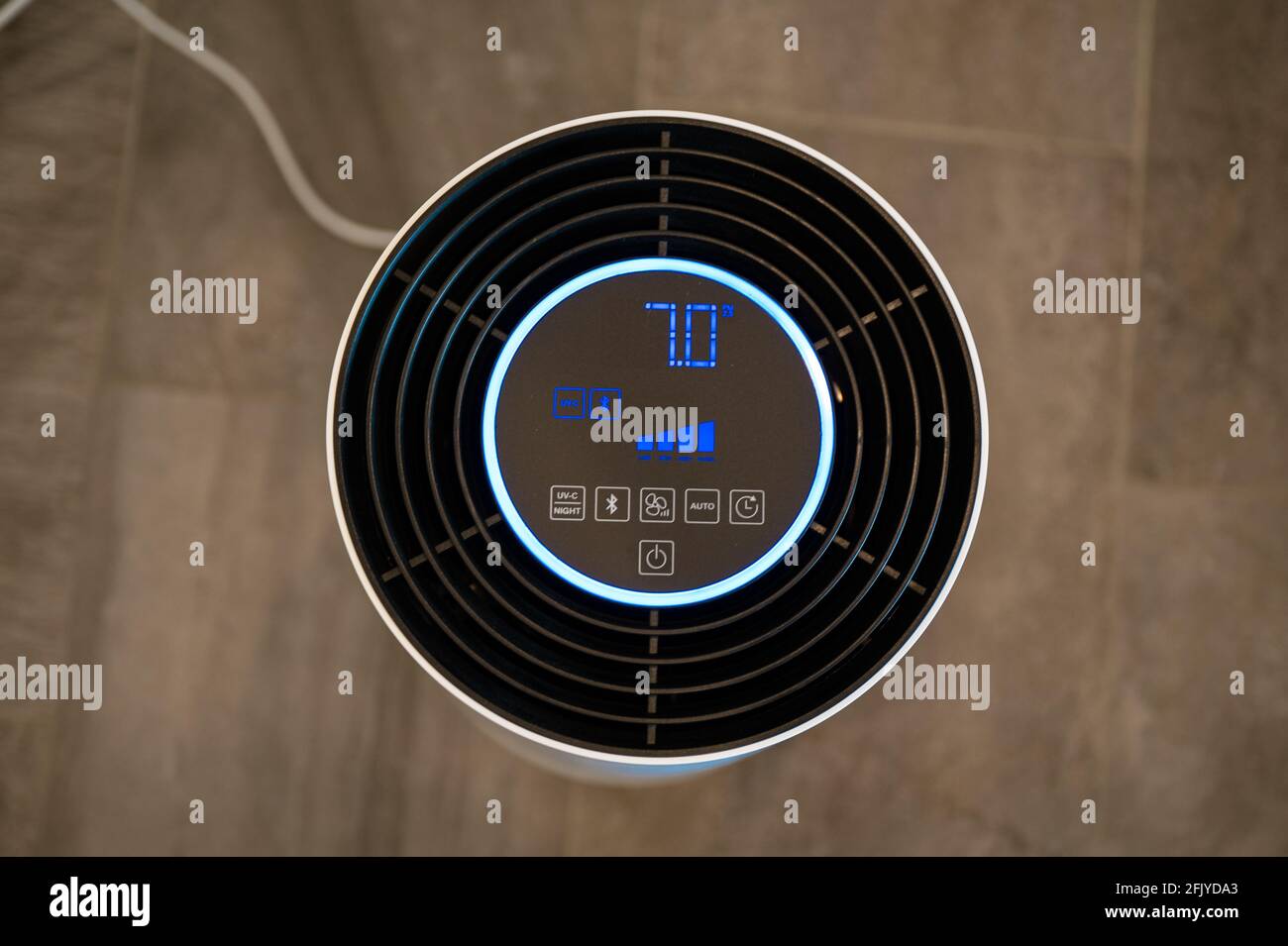 White UVC air purifier filters viruses and pollutants from indoor air