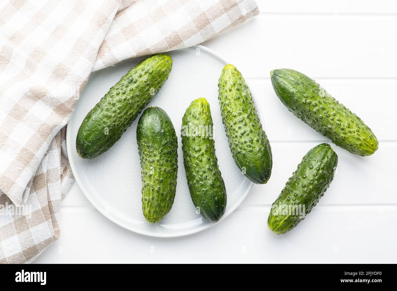 Fresh green cucumbers on white table. Stock Photo