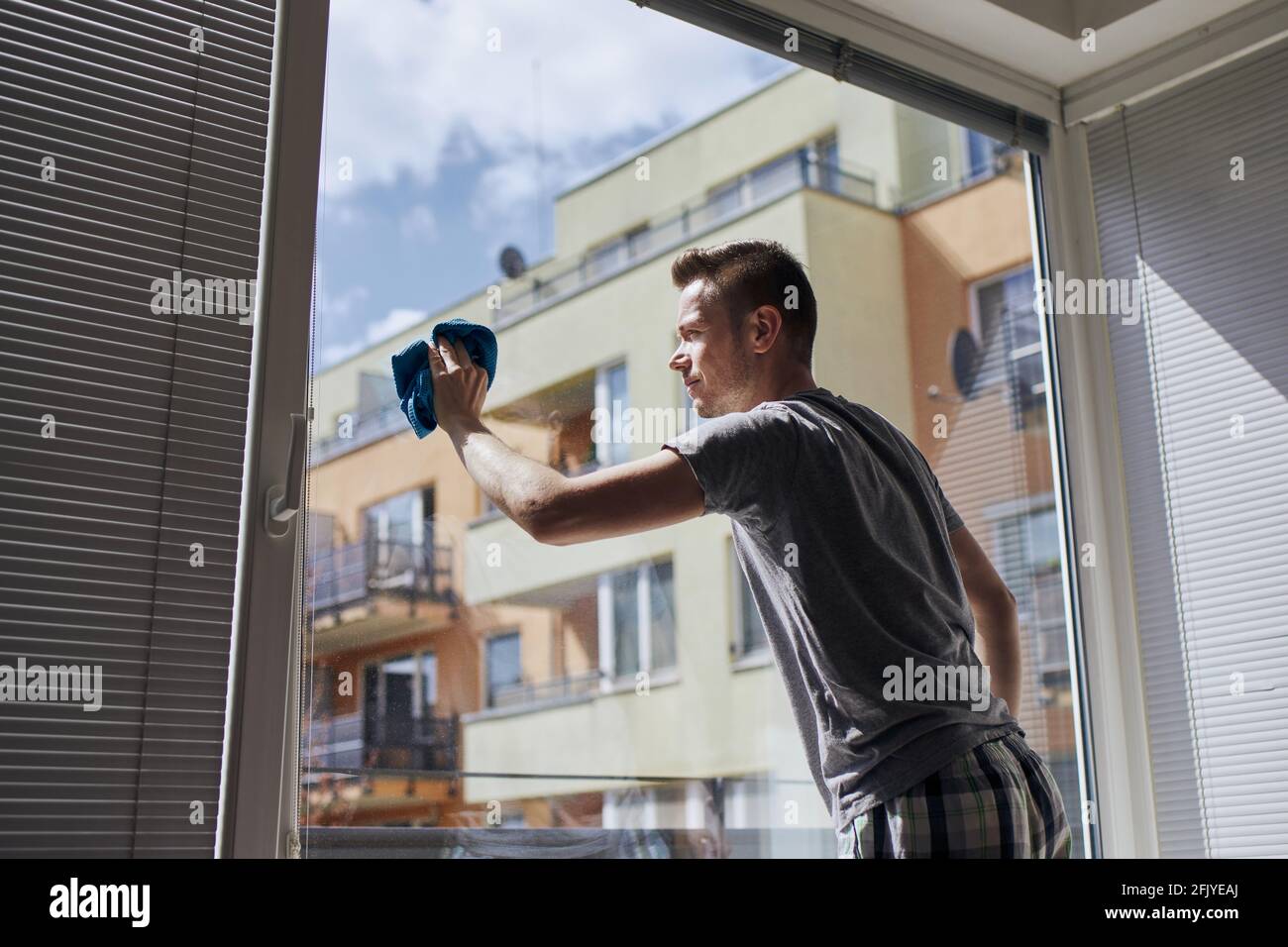 Man cleaning window with rag at home. Themes housework and housekeeping ...