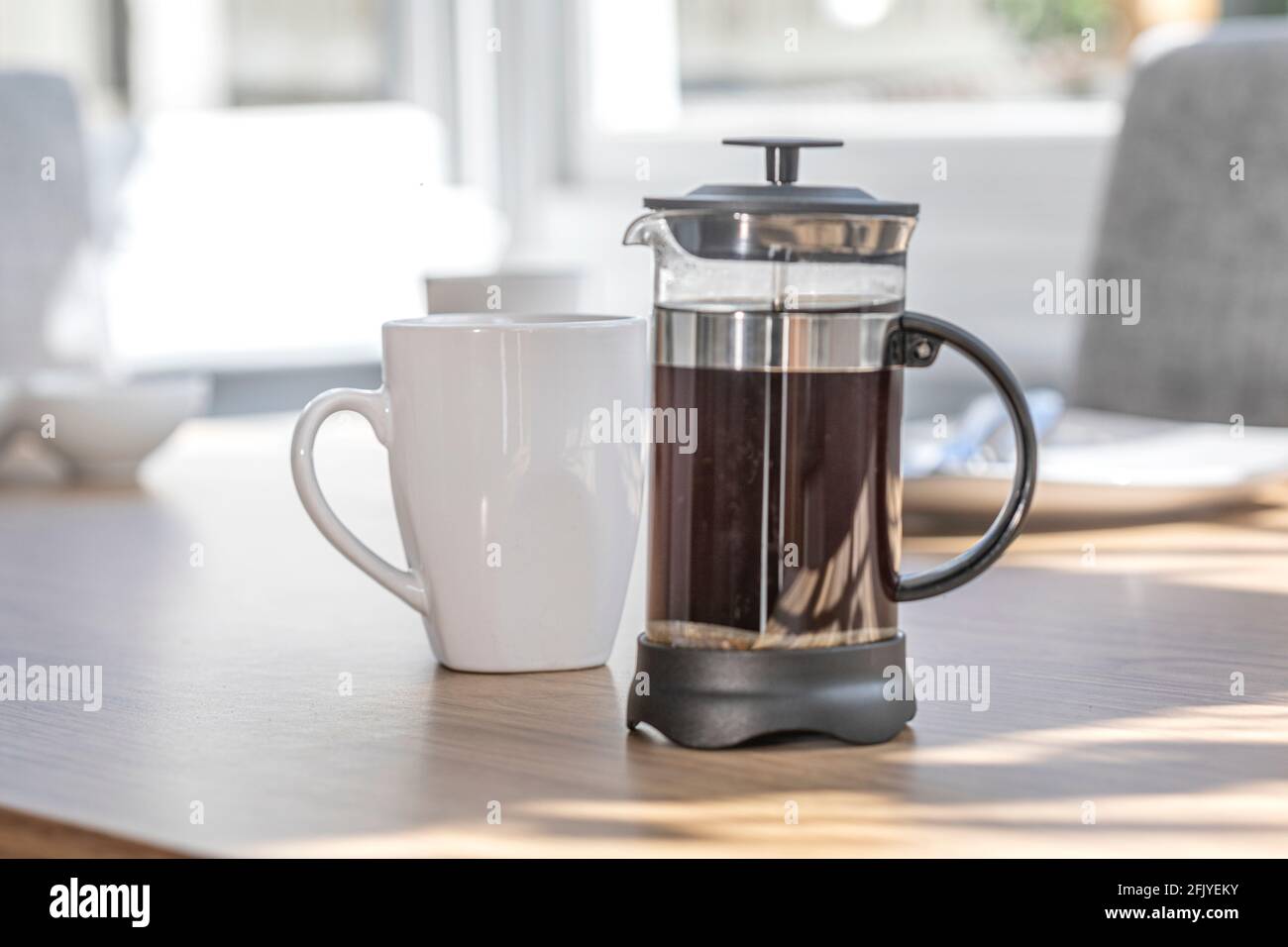 A Cafetiere and white coffee mugs Stock 