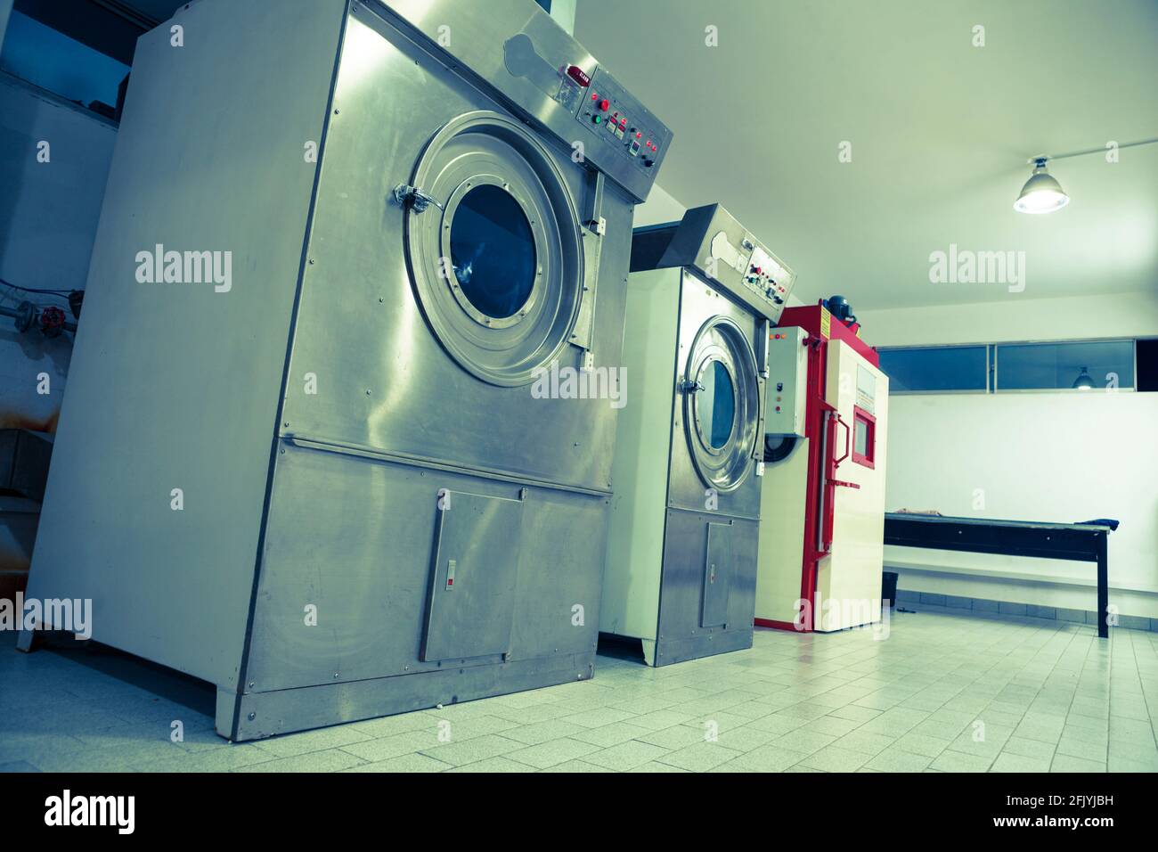 Front loading industrial washing machine. The rotary machines model LCO are machines designed for all kind of treatments on ready-made garments such a Stock Photo