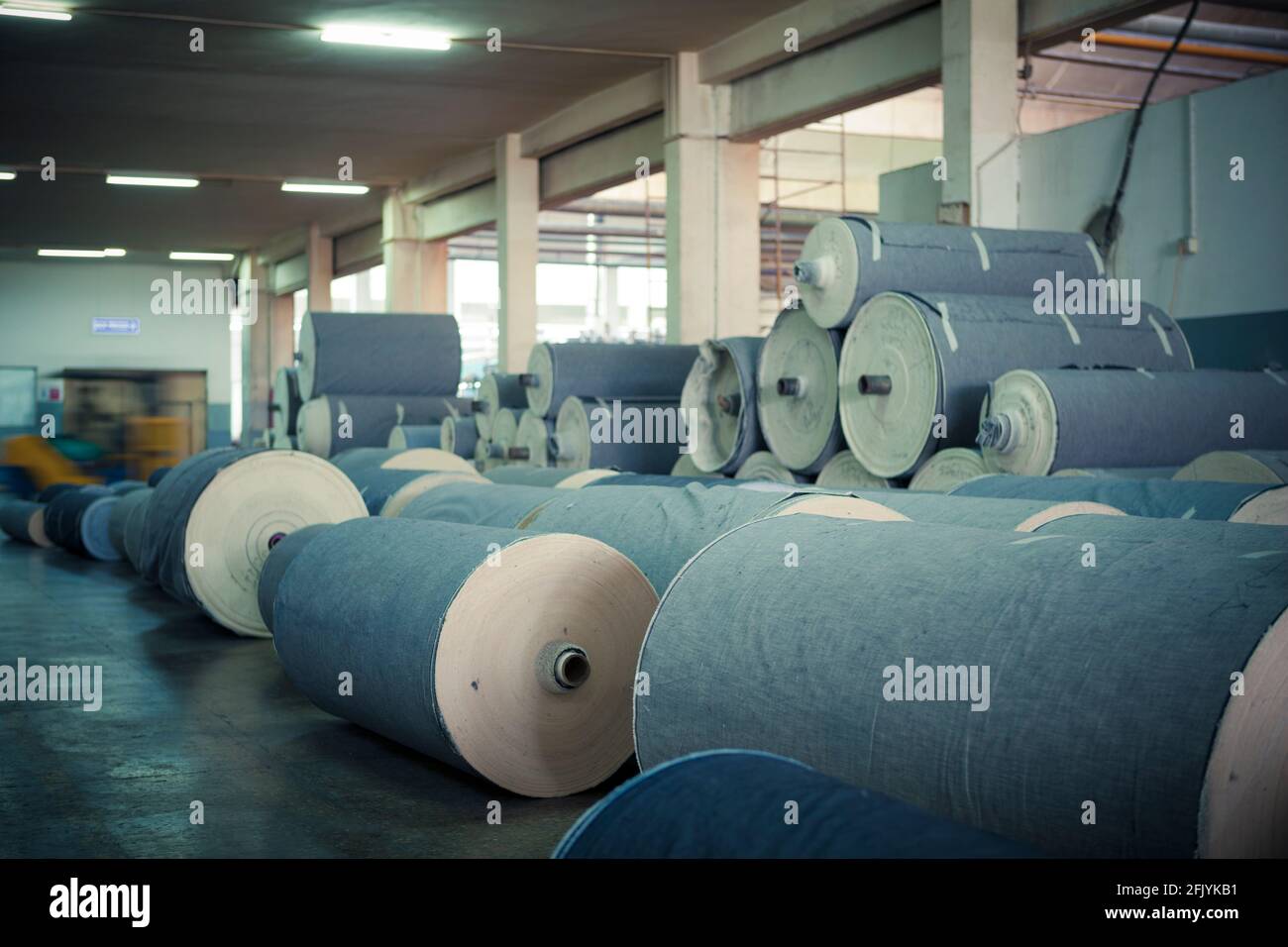 Denim fabric on big spools in a denim factory Stock Photo - Alamy