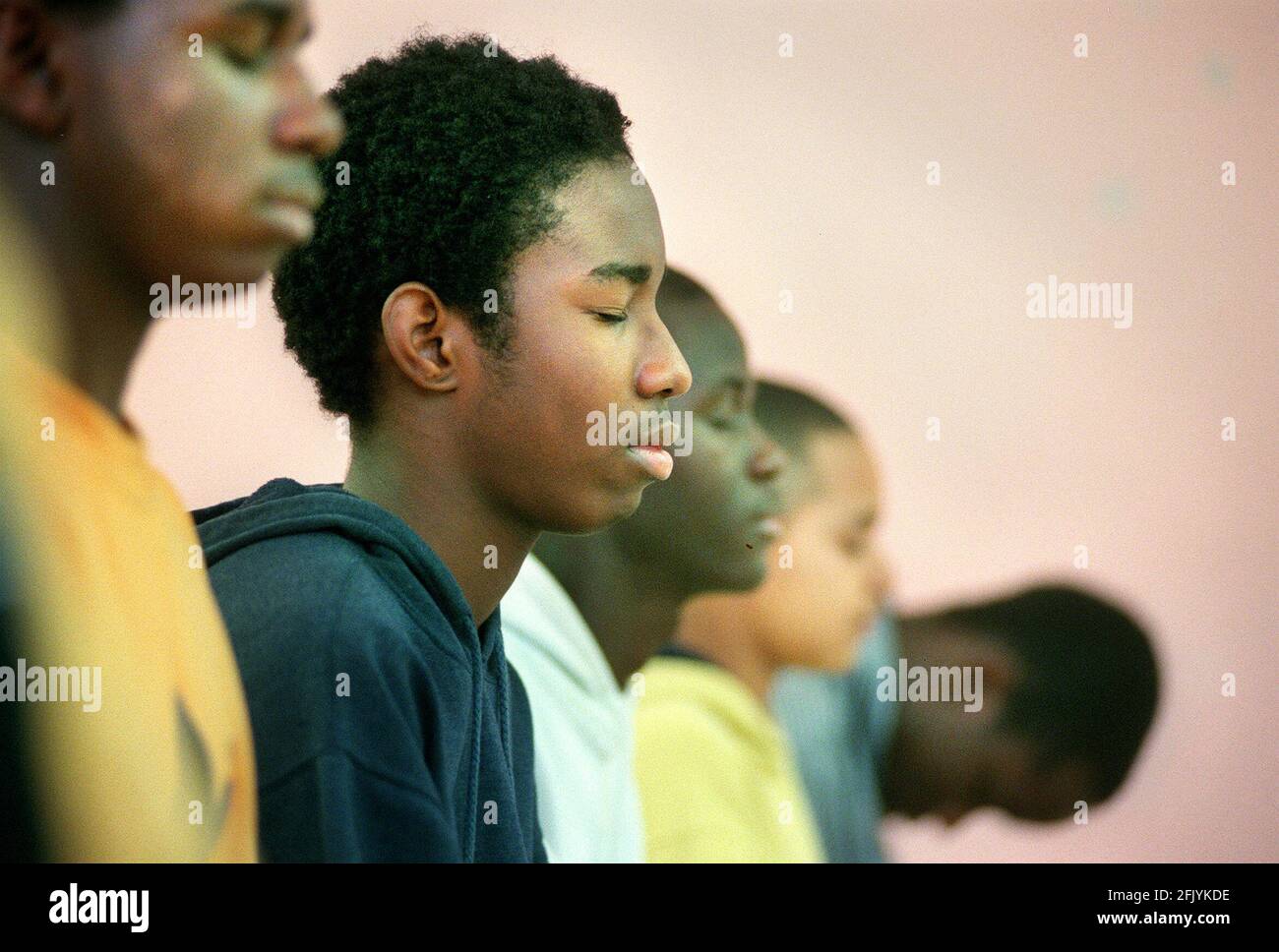 A MEDITATION SESSION AT THE BOYHOOD TO MANHOOD NOV 2000 FOUNDATION AT A COMMUNITY CENTRE ON THE NORTH PECKHAM ESTATE. THE FOUNDATION TAKES ON BOYS,SOME OF WHICH HAVE BEEN EXCLUDED FROM SCHOOL AND HELPS THEM COPE WITH  GROWING UP IN  A DIFFICULT ENVIROMENT. Stock Photo