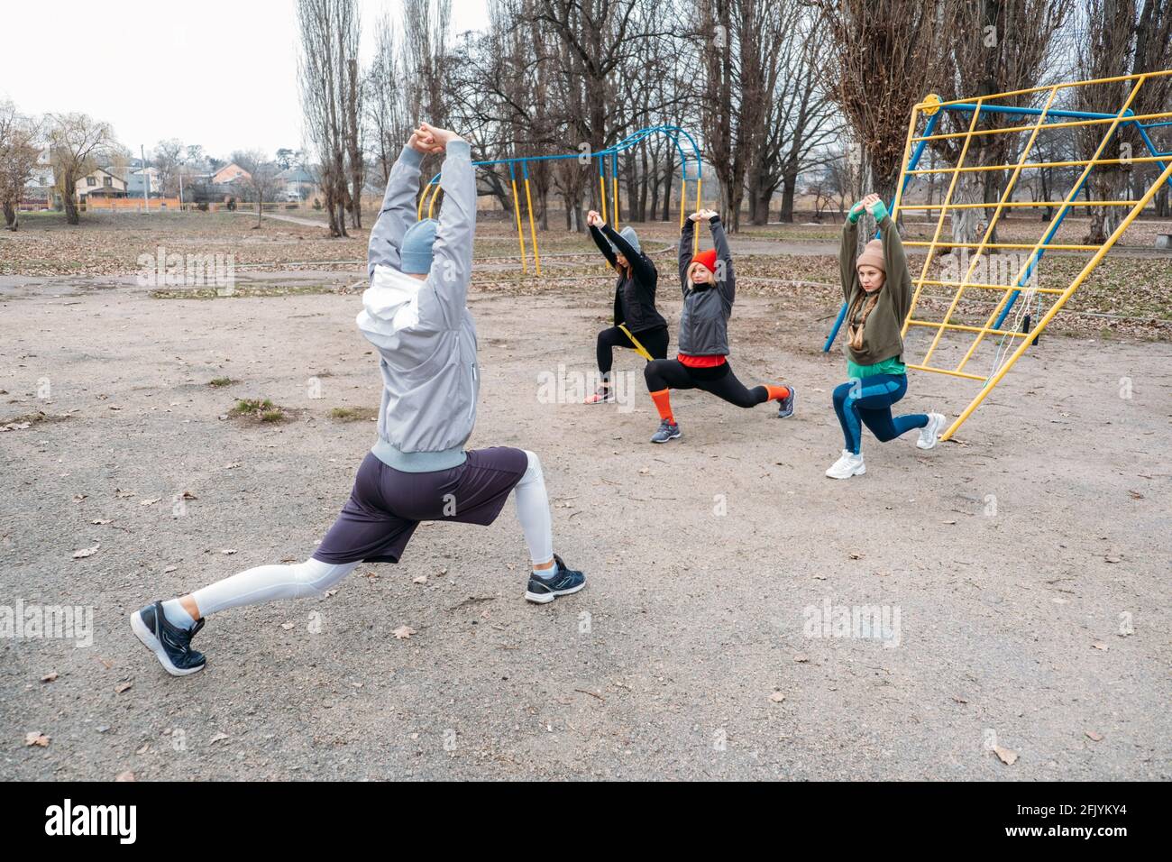 Group fitness workout classes outdoors. Socially Distant Outdoor Workout Classes in public parks. Three women and man training together in the public Stock Photo Alamy