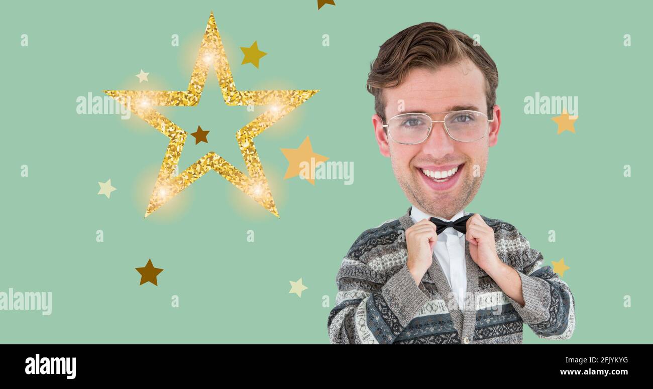 Composition of happy man holding bow tie and christmas stars on green background Stock Photo