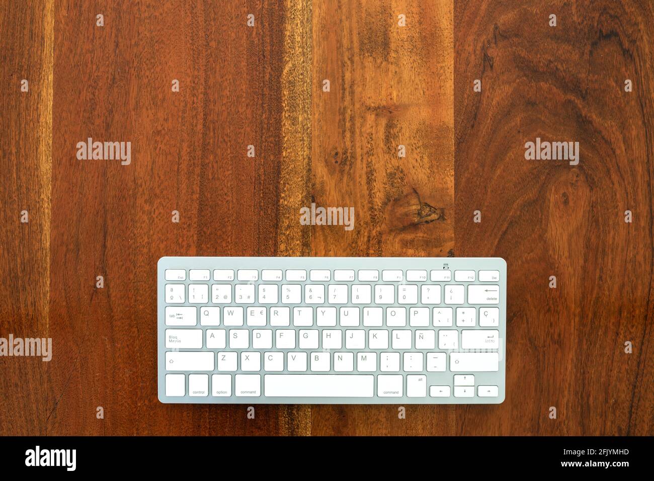 Wireless keyboard on wooden table. Stock Photo