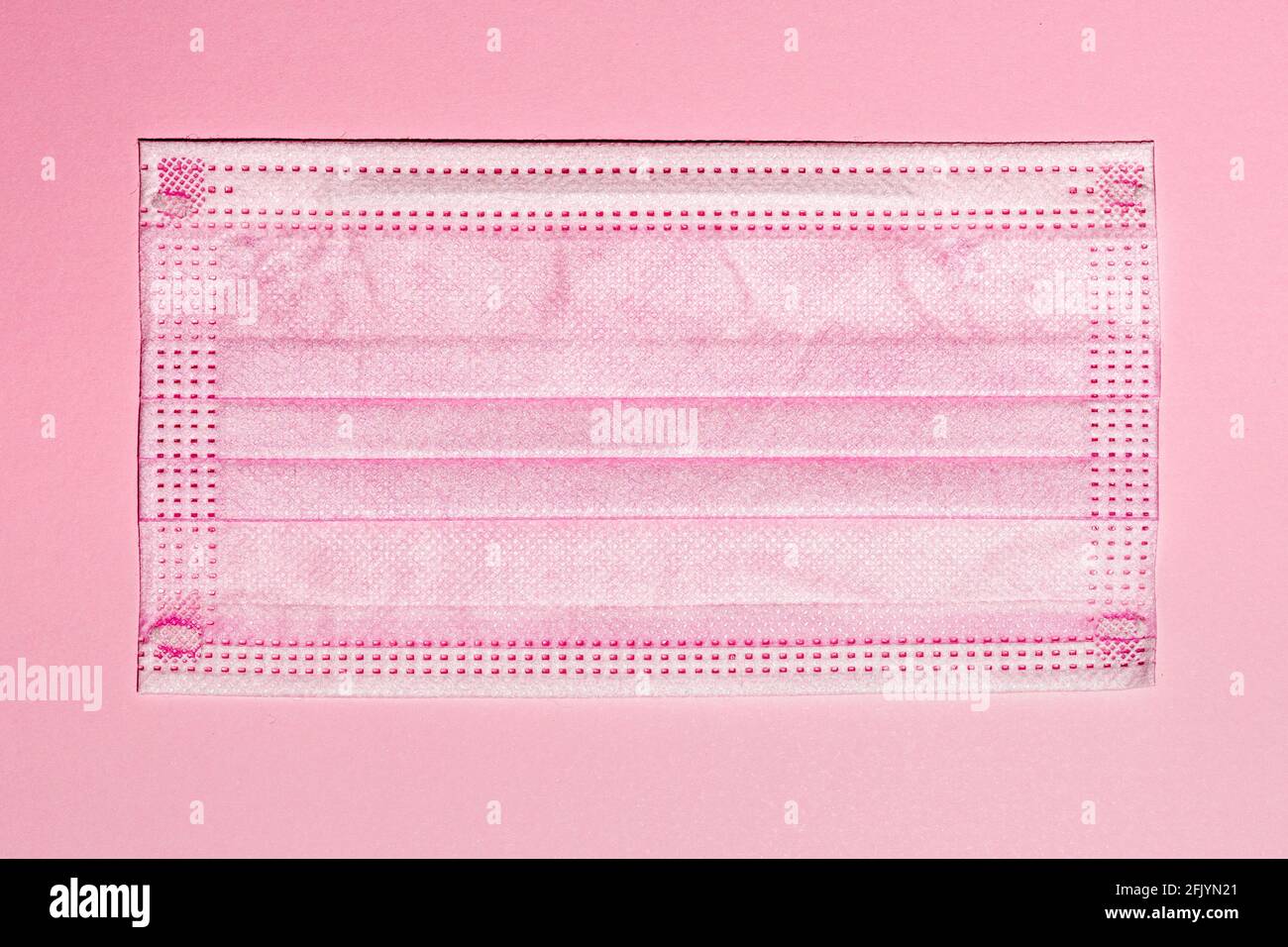 Pink surgical mask lay flat image on pink background Stock Photo - Alamy