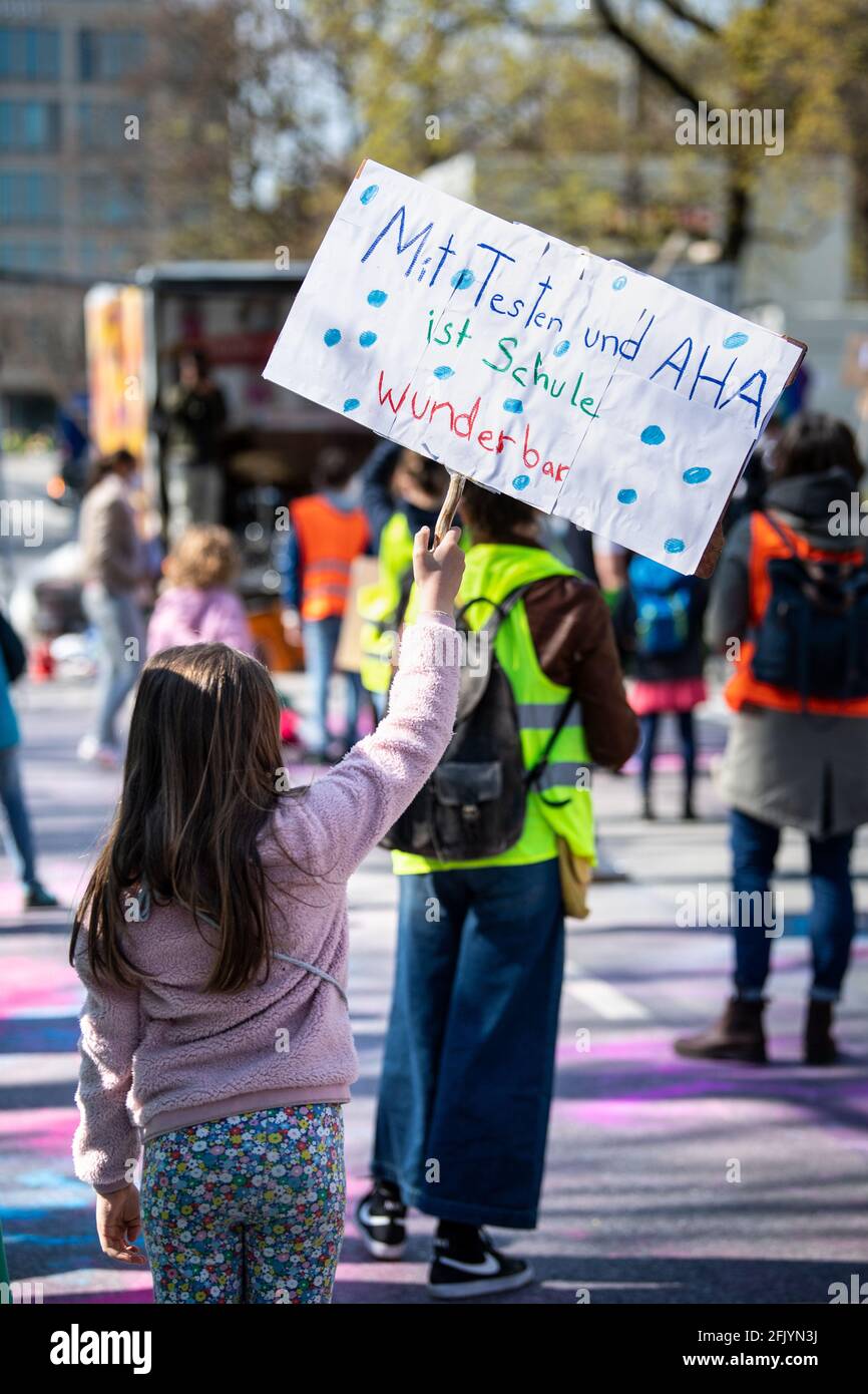 Munich, Germany. 27th Apr, 2021. A girl holds up a sign reading "With