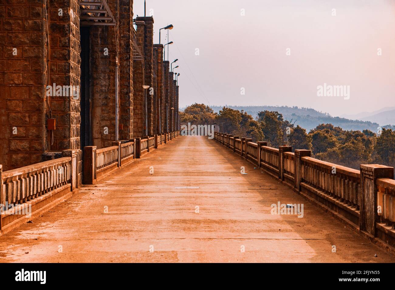 Beautiful alley by a stone bridge columns on a sunny day Stock Photo ...