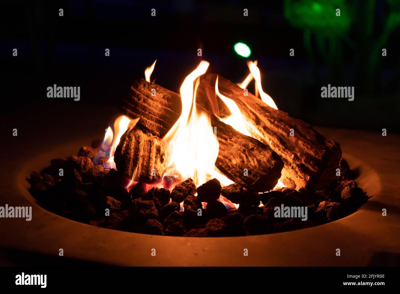 Roasting marshmallow over a gas fire while glamping Stock Photo