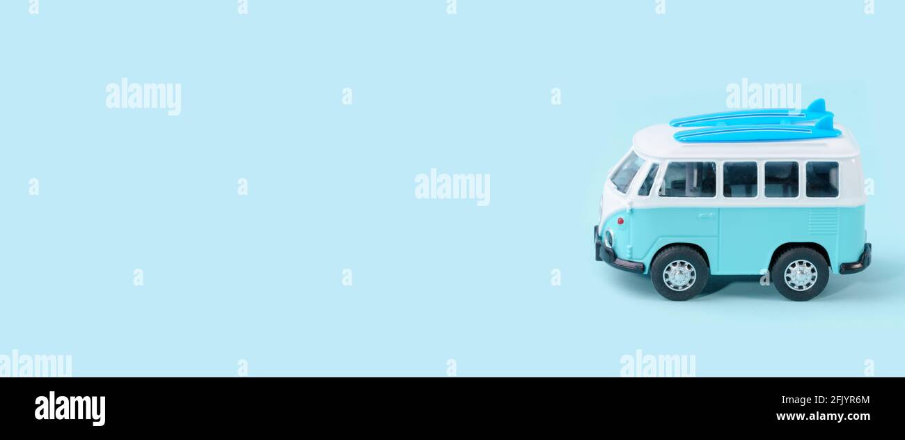 Vintage minibus for camping isolated on blue background. Miniature blue van. Stock Photo