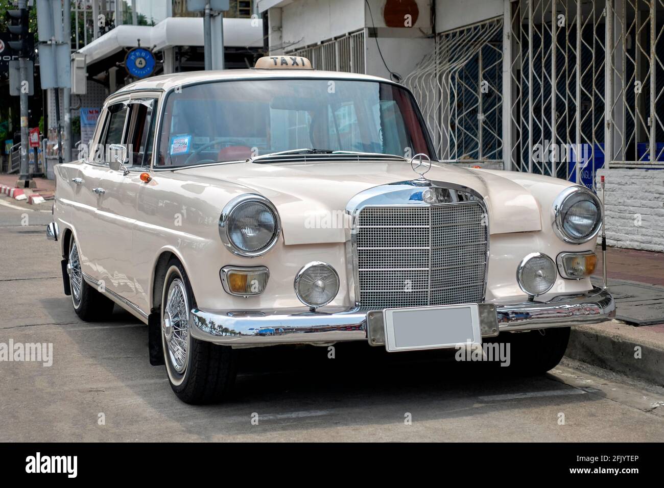 Mercedes-Benz 110 series 200 vintage 1968 German taxi saloon car in cream color Stock Photo