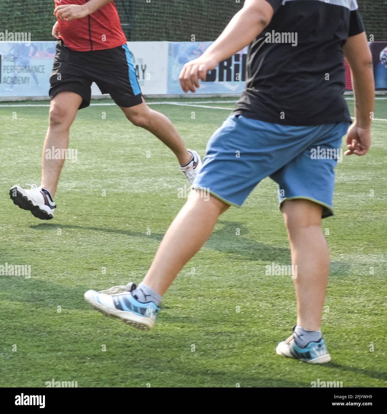 New Delhi, India - July 01 2018: Footballers of local football team during game in regional Derby championship on a bad football pitch. Hot moment of Stock Photo
