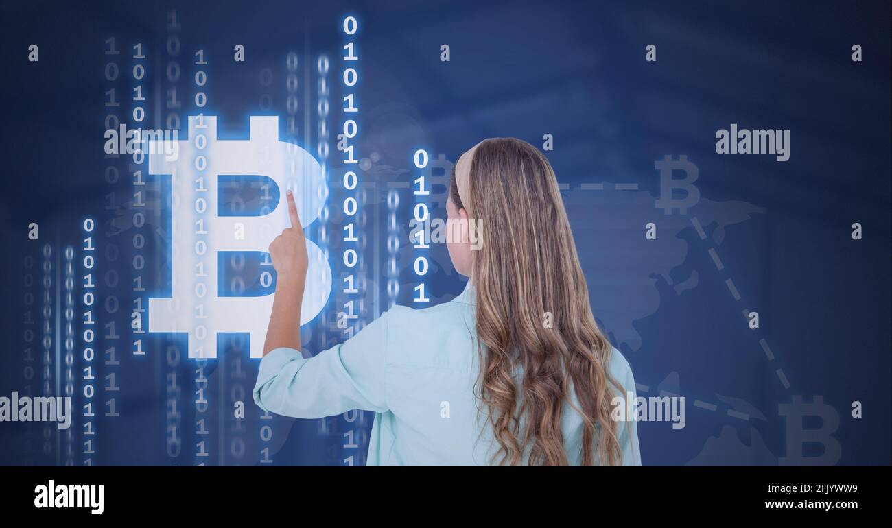 Composition of woman touching virtual screen with bitcoin symbol and binary coding Stock Photo